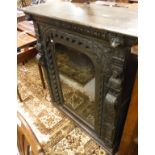 A Victorian carved oak Gothic revival side cabinet with single glazed door and figural and