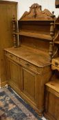 A pine chiffonier with open shelves above two drawers and two cupboard doors,