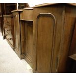 A 19th Century mahogany serpentine fronted sideboard with single drawer above cupboard door flanked