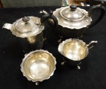 An early 20th Century silver four piece tea service to comprise teapot with ebony finial and handle