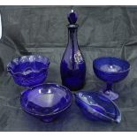A collection of cranberry, ruby and Bristol blue glass wares to include vases, bells, scent bottles,