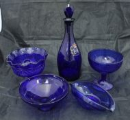 A collection of cranberry, ruby and Bristol blue glass wares to include vases, bells, scent bottles,