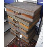 A collection of ten fabric and leather bound suitcases by Hartmann Luggage,