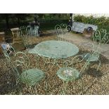 A painted metal garden table and five chairs (2 +3) and an extending ladder