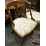 A set of six walnut framed dining chairs with cream and patterned upholstered seats,