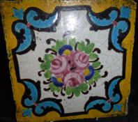 A Persian Qajar Dynasty pottery polychrome tile decorated with central floral spray within a