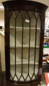 A 19th Century mahogany bow front wall hanging corner display cabinet with Greek key moulding