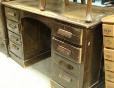 An early to mid 20th Century oak single pedestal desk,