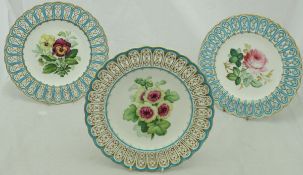 A set of five dessert plates with hand-painted floral central decoration and a pierced and shaped