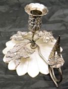 A mother of pearl miniature and white metal miniature candlestick and snuffer decorated with