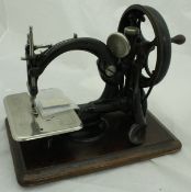 A circa 1880 Willcox & Gibbs chain stitch sewing machine with pack of spare grooved needles,