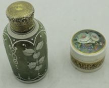 A white metal topped cameo glass bodied scent bottle with white applied decoration on the sage