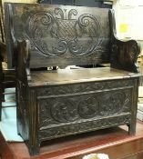 A collection of furniture comprising a circa 1900 carved oak monk's settle in the Gothic Revival