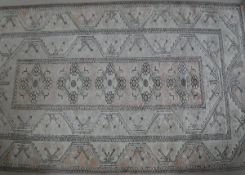 A Turkish rug, the central panel set with repeating lozenge medallions on a salmon pink ground,