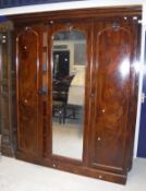 A Victorian mahogany wardrobe with central mirror door and hanging space to the right and linen