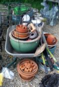 Two 19th Century cast iron boot scrape together with a collection of garden pots, two wheelbarrows,