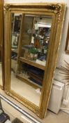 A large rectangular wall mirror in gilt and moulded frame