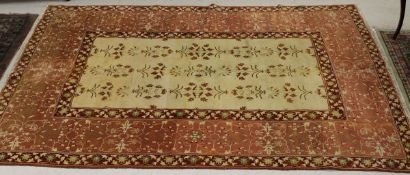 A modern Agra carpet, the cream central panel decorated with floral sprays,