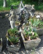 A collection of composite stone garden pots with Celtic knot style design,