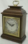 An Elliott mahogany cased mantle clock with Roman numerals to the steel dial,