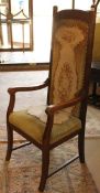An early 20th Century oak framed high back carver chair with needlework upholstered seat and
