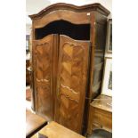 A 19th Century French fruitwood armoire with two door enclosing a hanging space