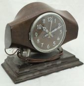 A mahogany cased mantle clock, the body as the central section of a propeller and inscribed "DRG.NO.