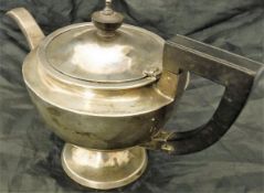 An early 20th Century silver teapot with ebony finial and handle inscribed "R.H.H. H.S.H.