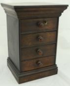 A Victorian miniature chest of four drawers, together with a rosewood sarcophagus shaped tea caddy,