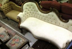 A Victorian walnut framed chaise longue with button backed cream upholstery and carved fruit and