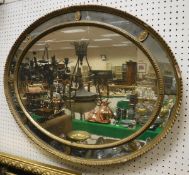 An oval multi-plate wall mirror with gesso moulded frame and a further mirror