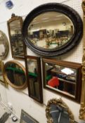 An assortment of wall mirrors to include a mahogany rectangular wall mirror, two oval wall mirrors,