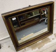 A rectangular wall mirror in moulded frame