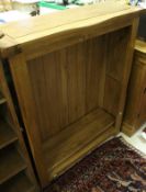 A modern oak bookcase, together with matching sideboard,