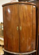 A 19th Century mahogany and cross banded bow front corner cabinet,