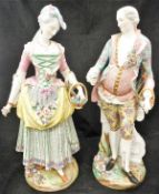 A pair of Dresden figures of a gentleman and a lady picking flowers,