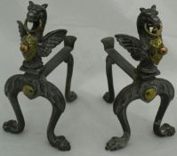 A pair of steel, brass and copper fire dogs,