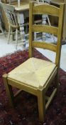 A set of six modern beech framed ladder back chairs with rush seats