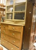 A pine chest of two short over three long drawers, raised on a plinth base,