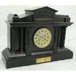 A Victorian black slate cased mantle clock of architectural form,