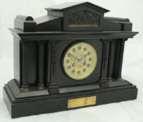 A Victorian black slate cased mantle clock of architectural form,