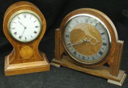 A mahogany and inlaid balloon-shaped mantle clock with Roman numerals to the dial,