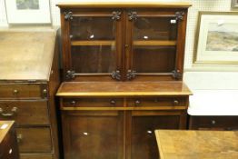 A Victorian mahogany cabinet with two glazed doors over two drawers and two cupboard doors on