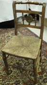 A set of five 19th Century ash dining chairs with shaped back rail with rush seats