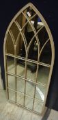 A small arched outdoor mirror