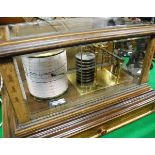 A barograph in five-sided glazed display case with retailer's label "Ollivant & Botsford of