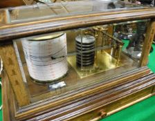 A barograph in five-sided glazed display case with retailer's label "Ollivant & Botsford of