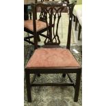 A set of four 19th Century Chippendale style dining chairs with pierced backs and red upholstered