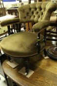 A Victorian salon chair with button back and upholstered arms,