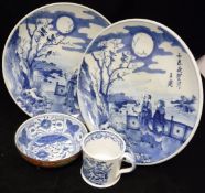 A pair of Chinese blue and white decorated plates with script to front and two figures,